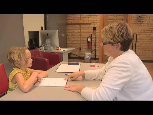 Emily Tonti teaching a child with severe dyslexia