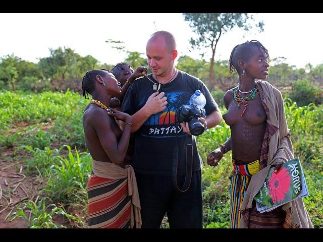 Africa: Girls are shocked by a white man. Wild Hamer tribe traditions and rituals.