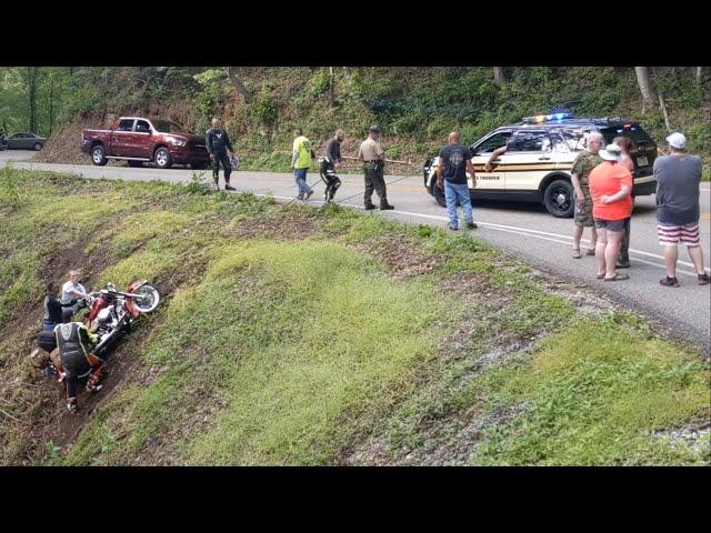 Tail of the Dragon- police and Tennessee Highway Patrol pull motorcycle out of gulch.