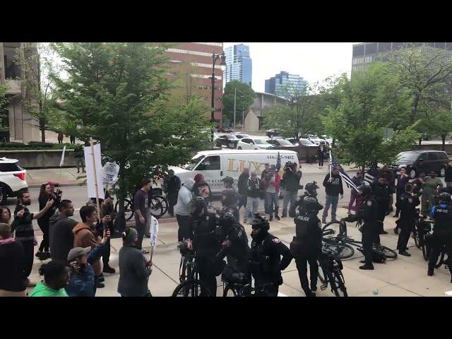 Police appear to use powder spray on protesters outside Schurr murder trial