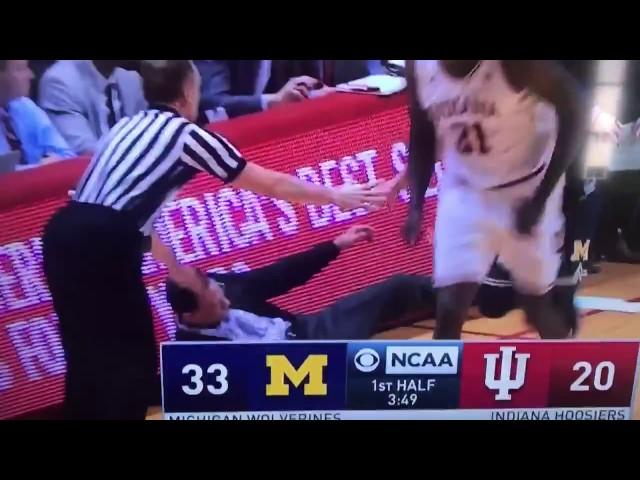 Michigan's Mo Wagner runs over Indiana coach Tom Crean after 3