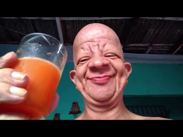 Old man drinks orange juice