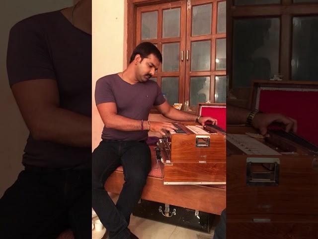 Pawan singh while playing harmonium