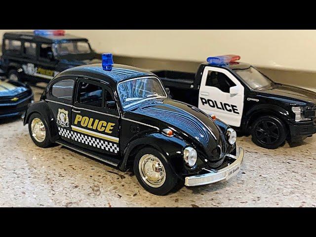 Various Diecast Police Cars Being Driven By Hand On Windowsill