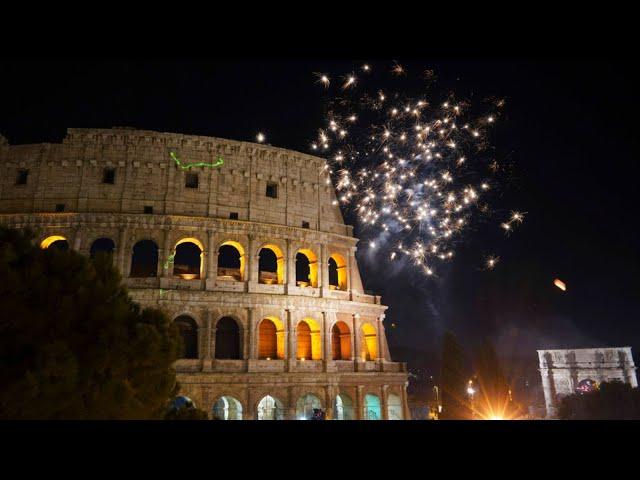 Happy New Year! Fireworks explode in the sky over Rome's Colosseum