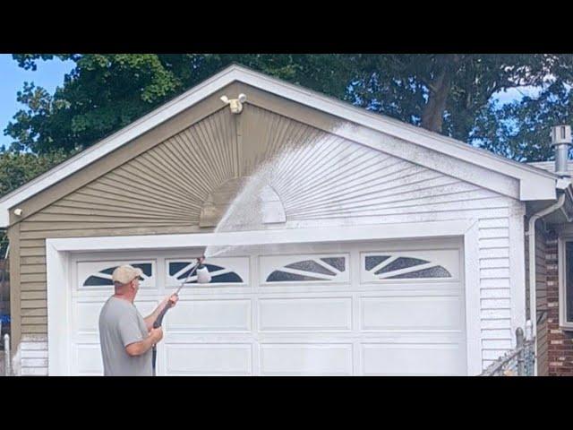 Foam cannon on a house pressure washing and painting job