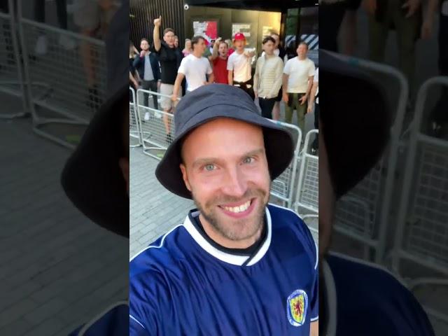 England crowd reacts to a Scotland fan walking in wearing a Tartan Army jersey