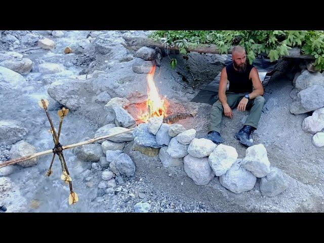 Primitive shelter in the Alps - bushcraft water wheel - slow cooked giant trout