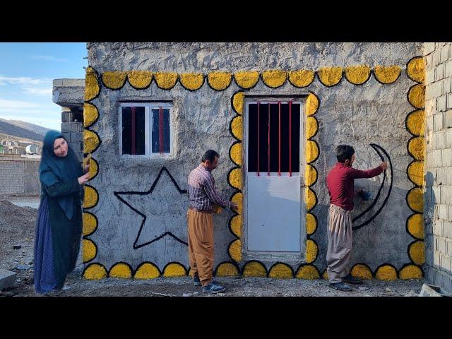 Abbas painting the front of the house with the help of his father