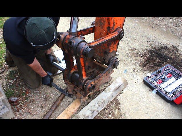 Abandoned digger gets new bucket/hitch pins and widens a narrow trail.