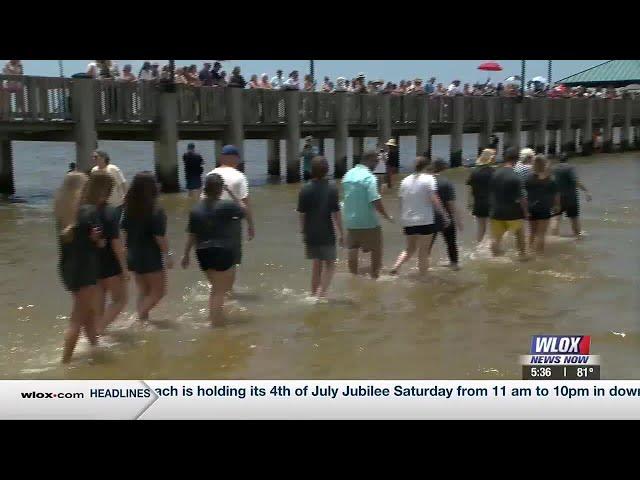 Local church holds public baptism on the beach in Ocean Springs