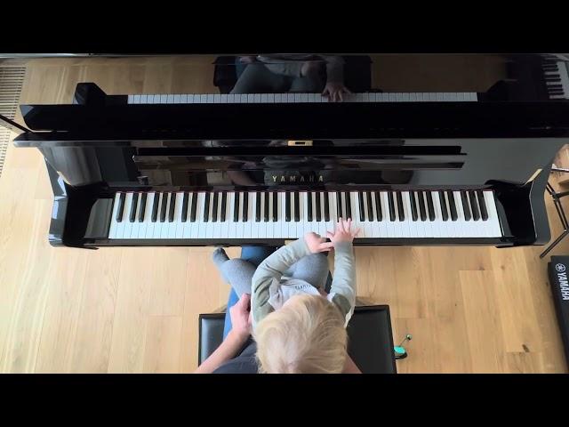 1 year old boy is playing piano. Little Khmara 
