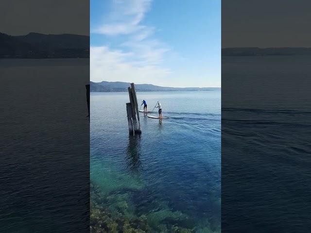 Stand up paddlers enjoy the view - Garda, Lake Garda, Italy