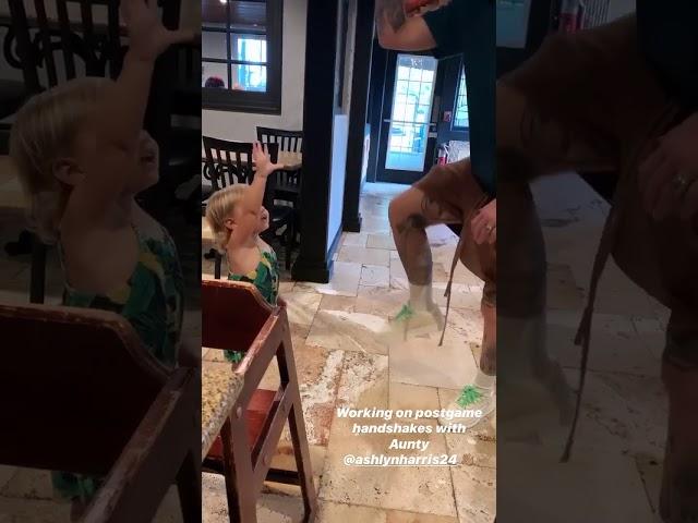 Ashlyn Harris teaches goddaughter handshake