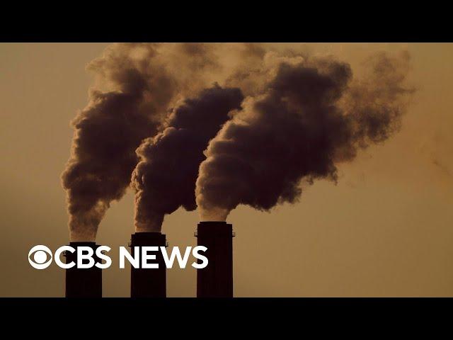 What are greenhouse gases and how do they contribute to climate change?