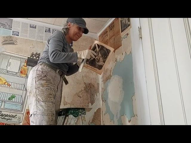 #2 Decoupaging kitchen walls with historic newspapers, magazines and travel items left in home.