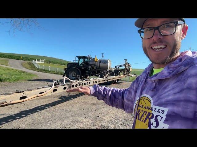 A tractor, a fire, and a spray plane flying low