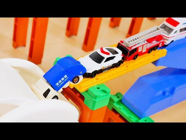 Various Working Cars Drive Down the Slope and Jump into a White BOX