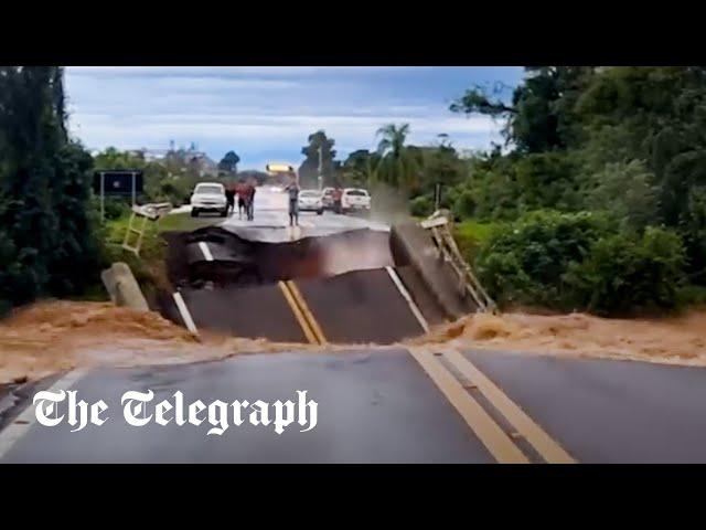 Brazil floods: Man narrowly avoids death after motorway bridge collapses