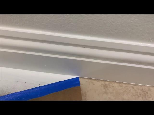 Spraying baseboards with Emerald Urethane Trim Enamel