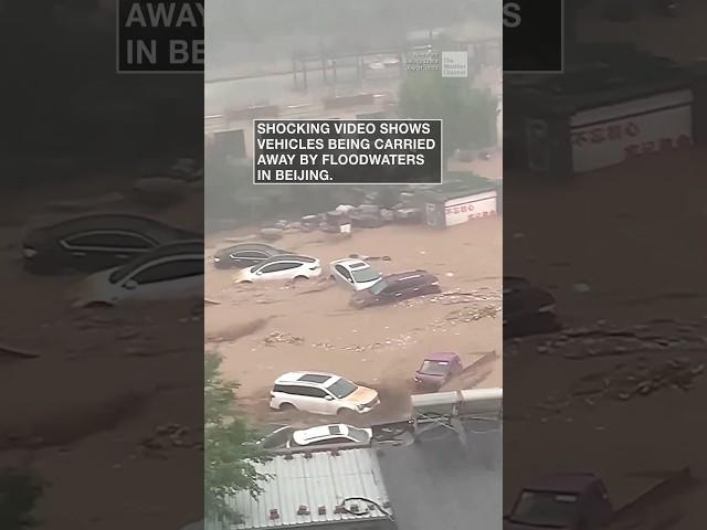 Cars carried away by Beijing flood