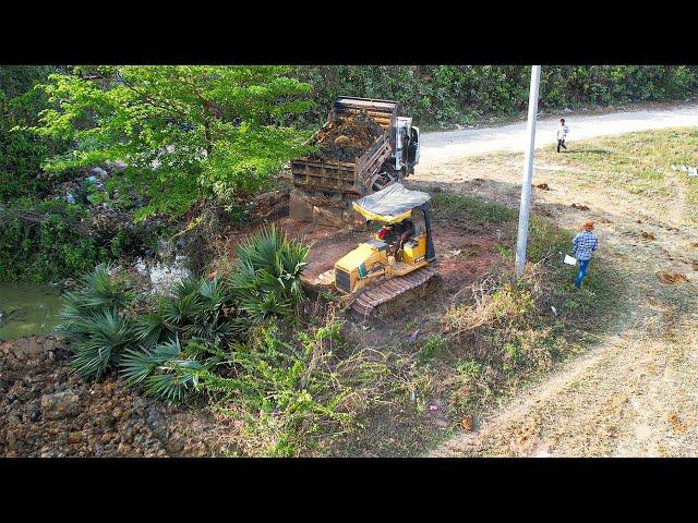 New Project Excellent By Dump Truck Dumping Soil On The Water With Small Dozer Pushing Dirt