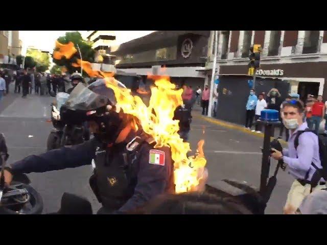 Police officer set on fire during protests in Mexico