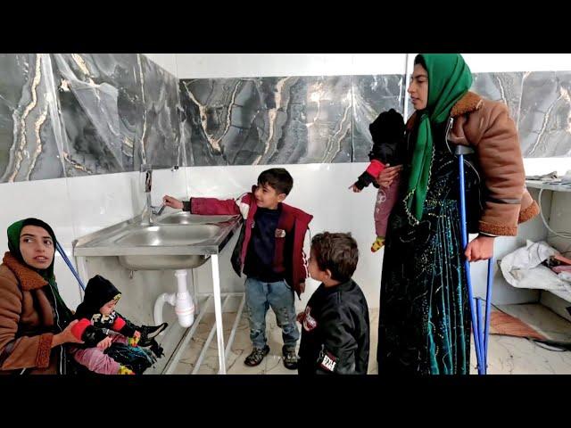 Taybeh a single nomadic mother, has reached the stage of installing a water heater in construction.