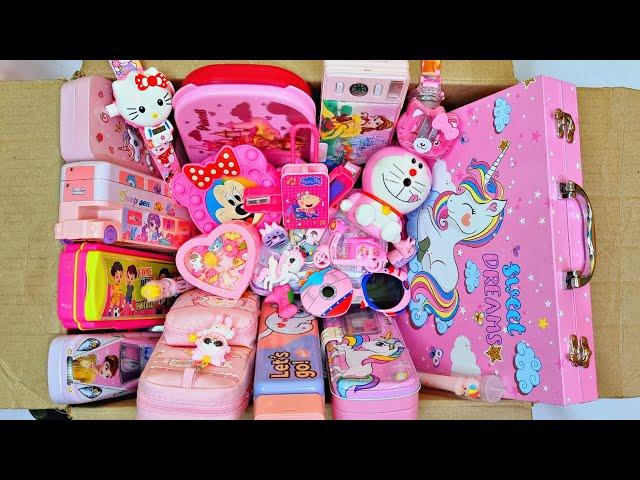 Box full of pink stationery - doraemon sharpner, password lock pencil box, projector watch, eraser