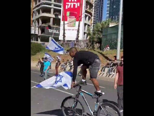 BICYCLE STUNT DURING PROTEST WITH ISRAELI FLAG