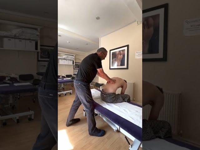 Massage with movement; working on the erector spinae group in seated position