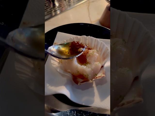 Pouring the brown butter, rum,lime sauce over the delicate hokkaido scallop at Bar Banane in Toronto