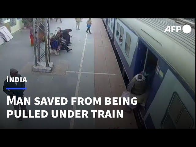 Indian soldier saves man from being pulled under a moving train | AFP