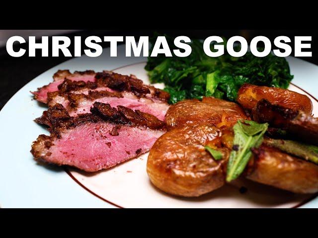 Roast goose with Christmas spices, black cherry gravy, goose-fat roast potatoes and mustard greens