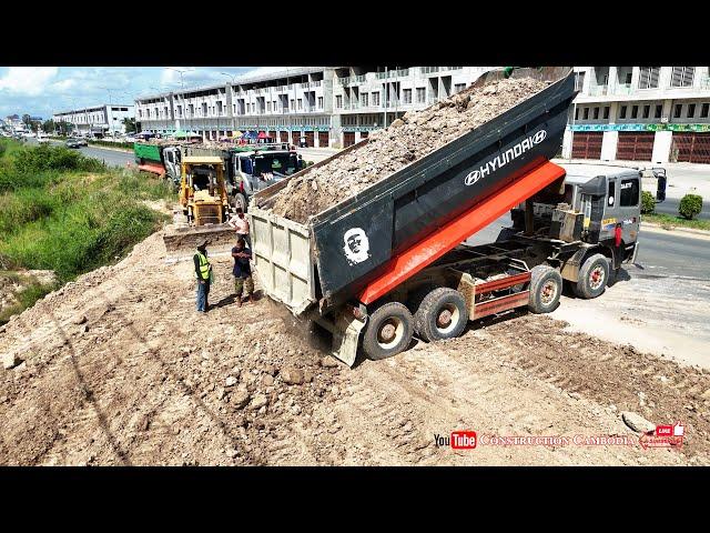 Massive Hyundai Dump Trucks Dumping Soil With Komatsu D41P Bulldozer Pushing Soil Filling Project