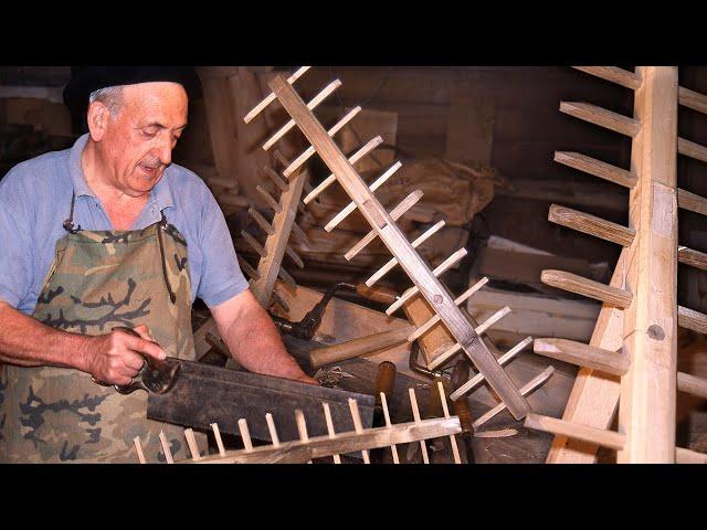 Wooden rake without nails or screws to collect and store grass in the field