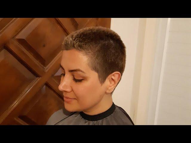 woman headshave blond long hair in barbershop by man