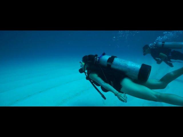 Scuba Diving Couple explore Undersea Realm