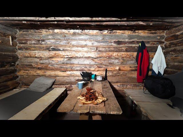 Alone in a Log Cabin in the Woods After a Snowfall. Winter Wilderness