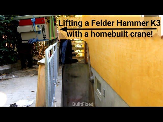 Lowering a Felder Hammer K3 table saw into a basement workshop