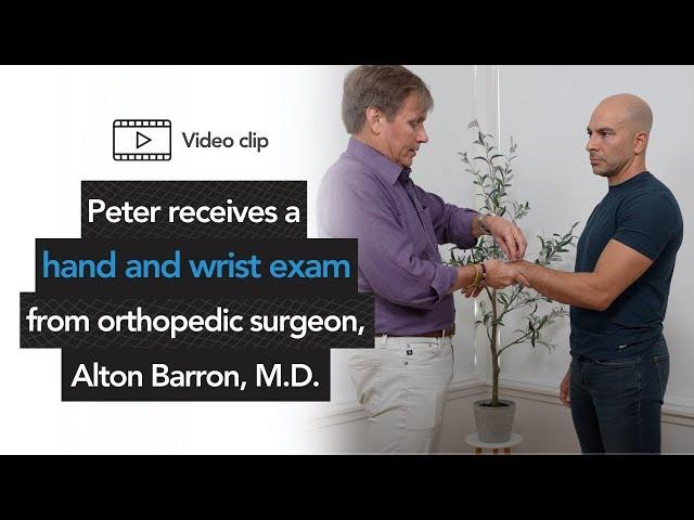 Peter receives a hand and wrist exam from orthopedic surgeon, Alton Barron, M.D.