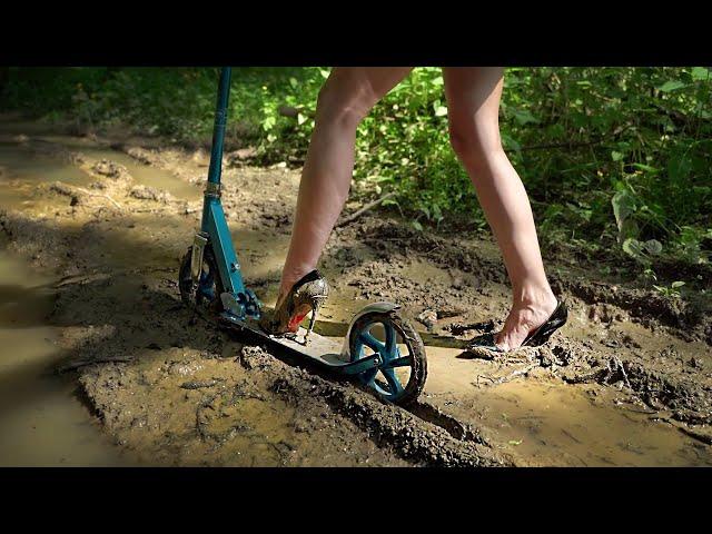 Girl in high heels on scooter in mud, high heels in mud, muddy louboutin, high heels stuck (# 774)