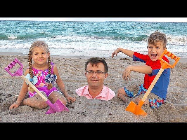 Diana and Roma play with Dad on the Beach