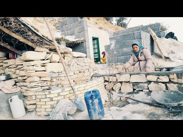 Strong hands of a pregnant mother: starting to build a platform with stones and cement