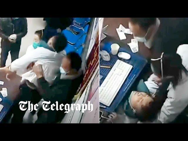 Exhausted doctor collapses during check-ups as China buckles under rising Covid-19 cases