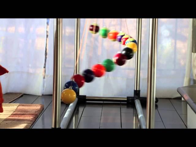 A simple demo of order and chaos (and order again) - Home made Pendulum Wave with 15 billiard balls