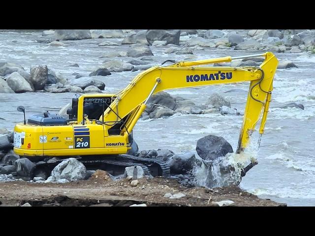 Excavator Down To The River Working For The Dam Reinforcement Construction