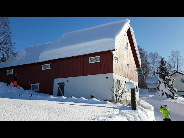 Using rope to remove snow from a roof.