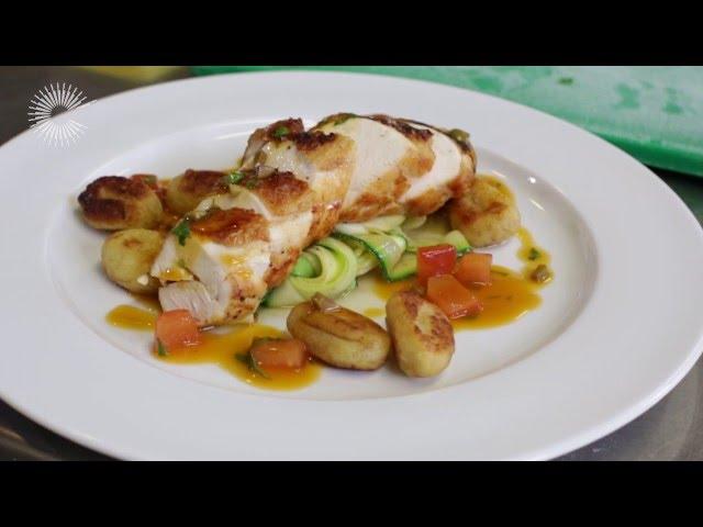 Breast of chicken with gnocchi, courgette ribbons and a tomato and olive sauce by Russell Brown