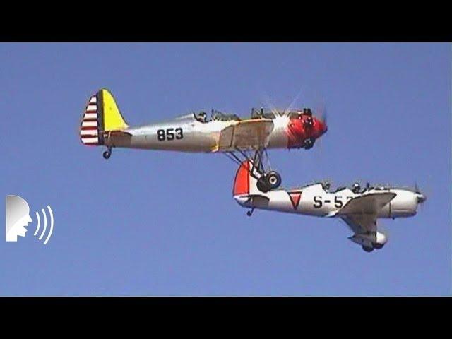 Vintage monoplane and biplane fly-by